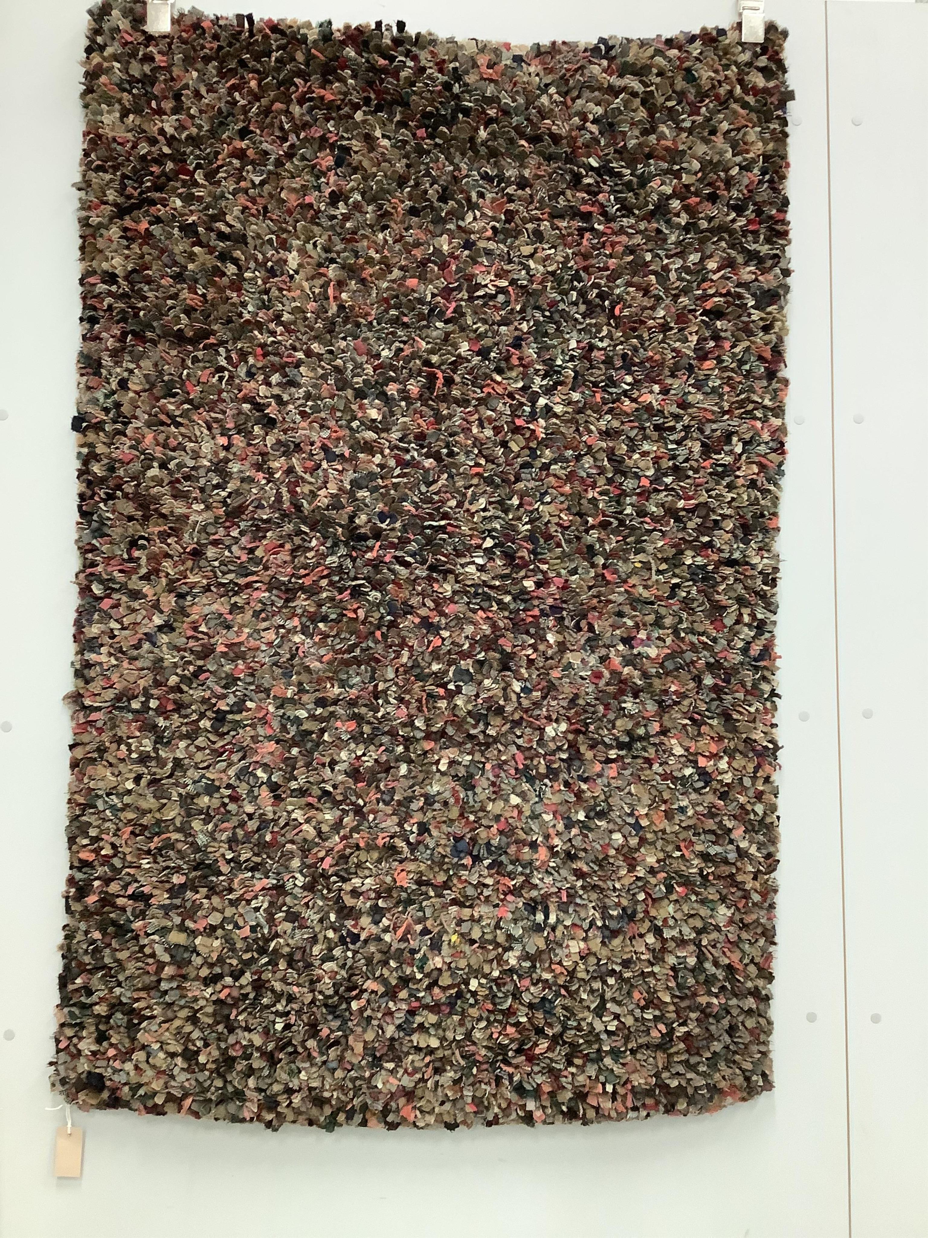 A polychrome rectangular rag rug, approximately 150 x 100cm. Condition - fair